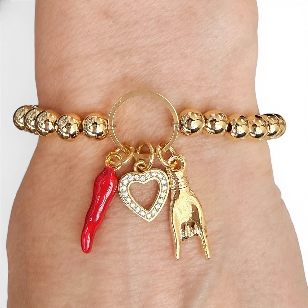 Love Lisa Mariano love protection bracelet gold  worn on wrist with heart and horn charms