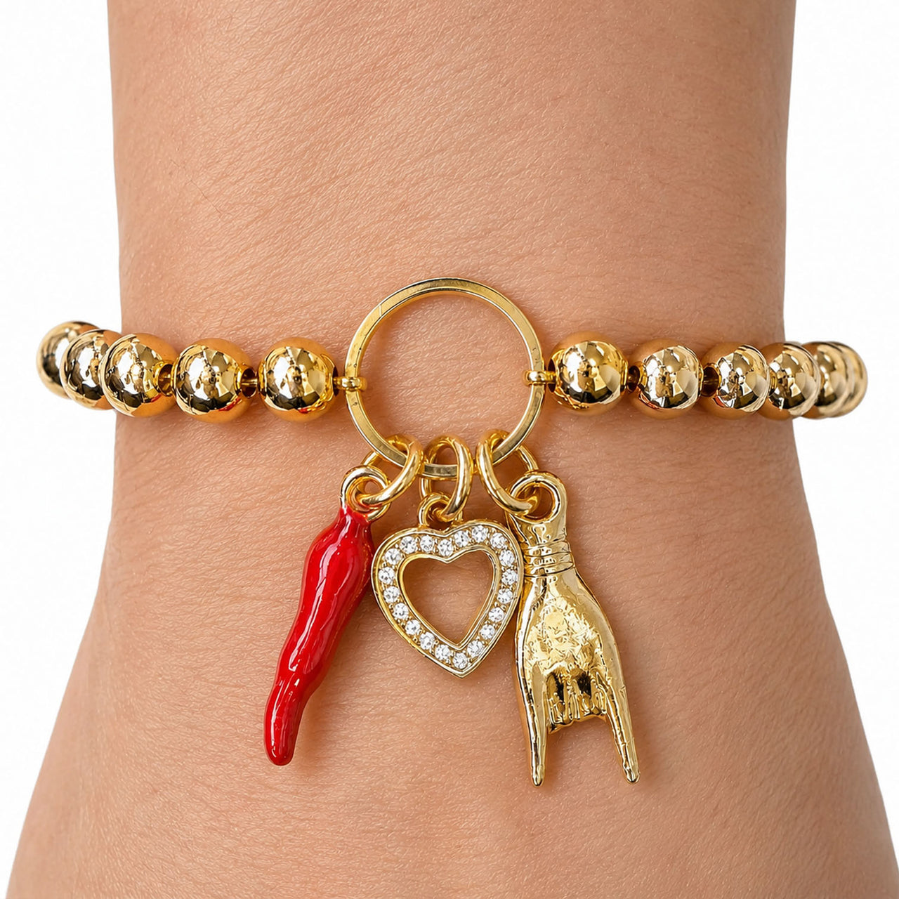 Love Lisa Mariano love protection bracelet gold  worn on wrist with heart and horn charms