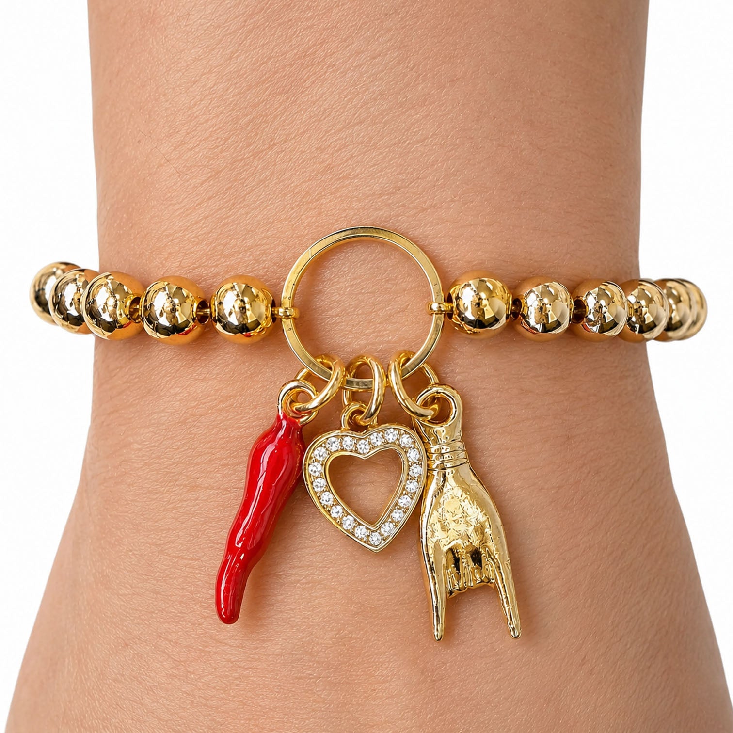 Love Lisa Mariano love protection bracelet gold  worn on wrist with heart and horn charms