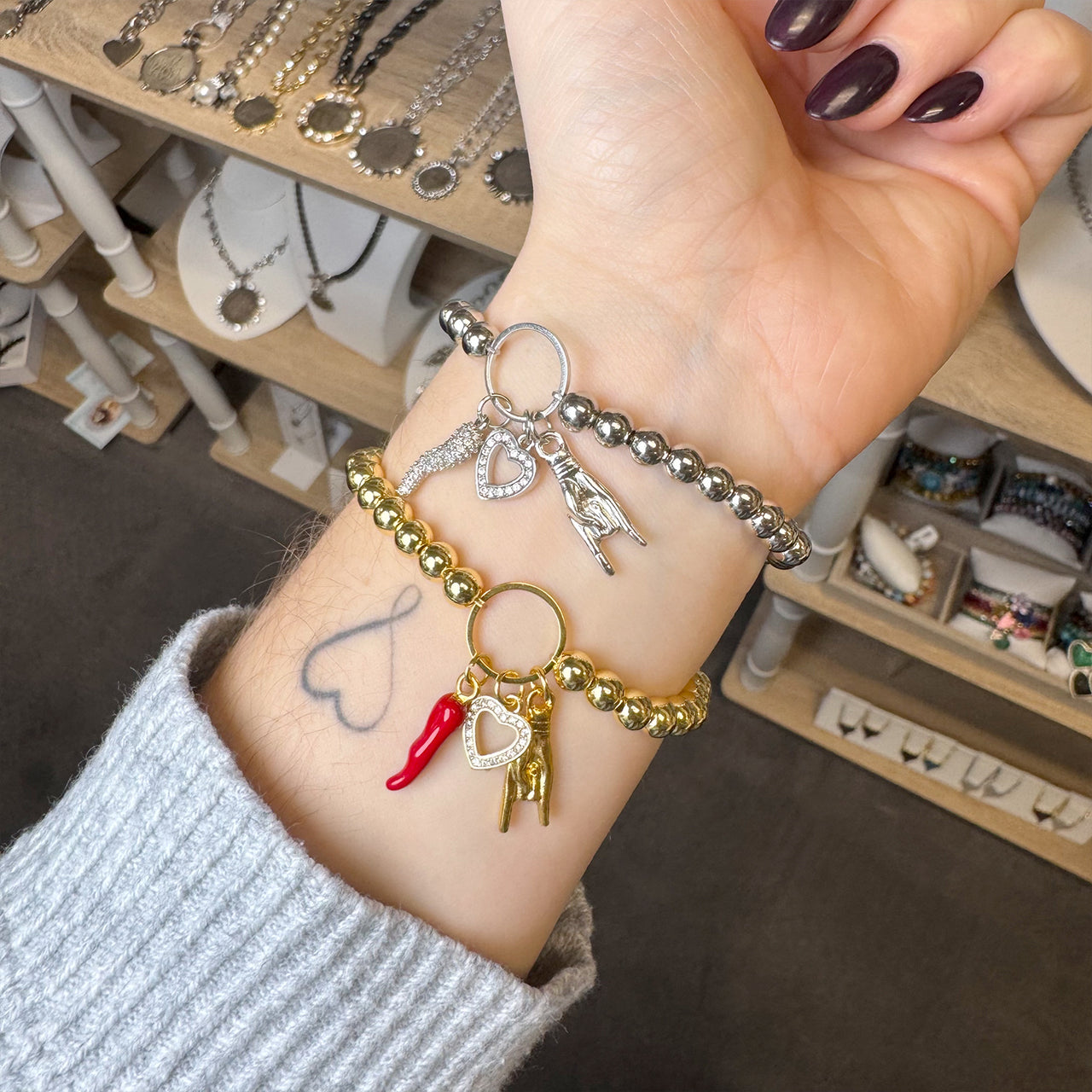 Love Lisa Mariano love protection bracelet styled in gold wrist stack with Italian horn charms