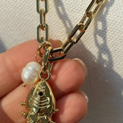 Love Lisa Maris Pearl Fish Charm Necklace close up showing polished gold paperclip chain freshwater pearl accent and detailed fish charm