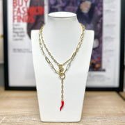 Close-up of gold Martina Necklace showing Italian horn and Mano Cornuto charms on paperclip chain.