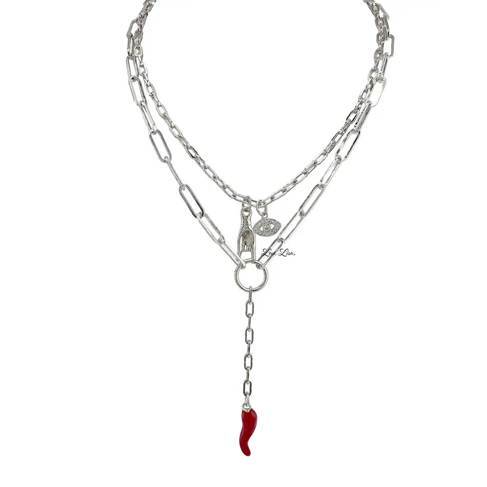 Flat lay of silver Martina Necklace displaying Italian horn and Mano Cornuto charms on layered chain.