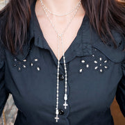 Love Lisa mary cross rosary lariat necklace worn long showing layered lariat styling
