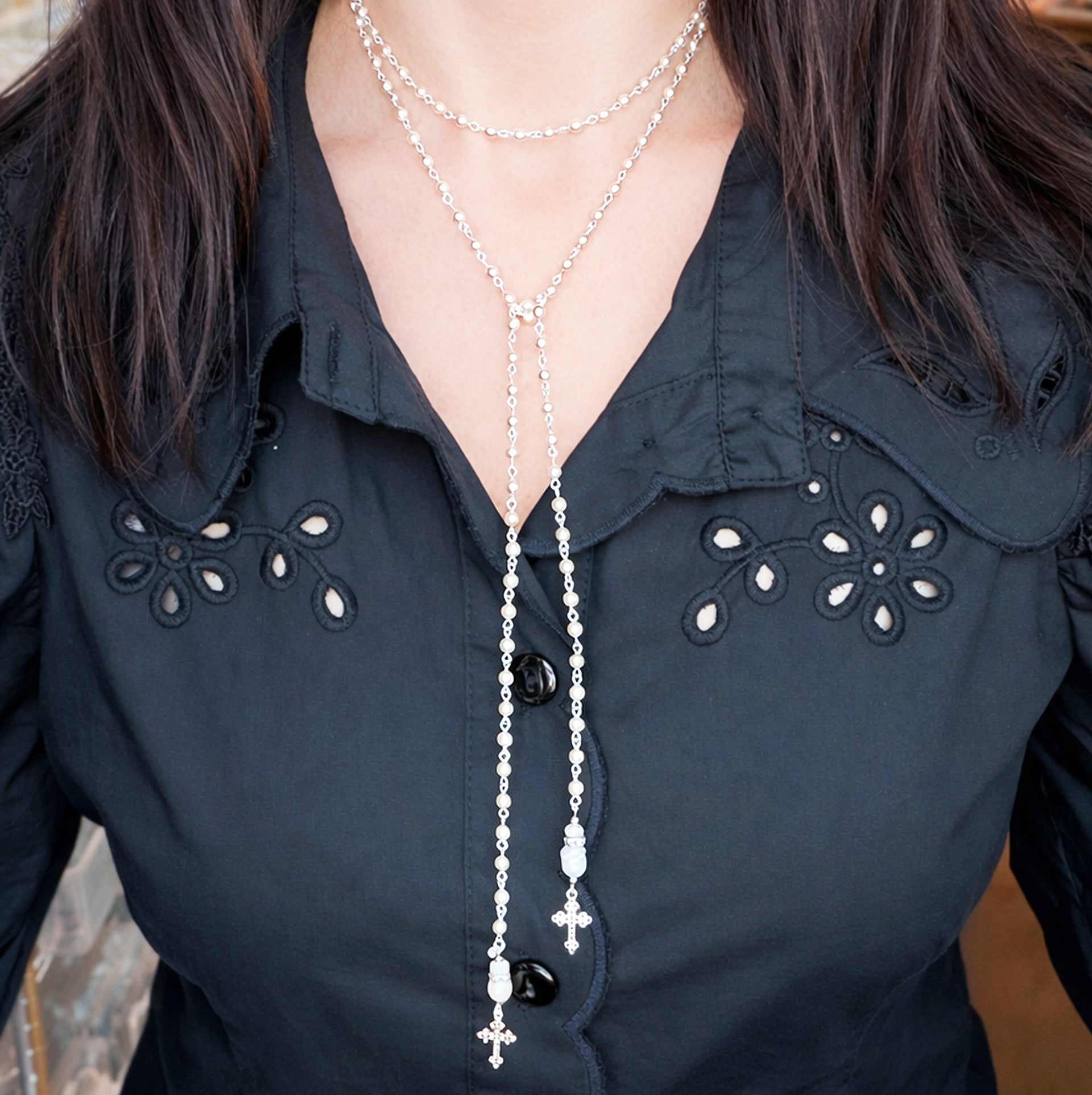 Love Lisa mary cross rosary lariat necklace worn long showing layered lariat styling
