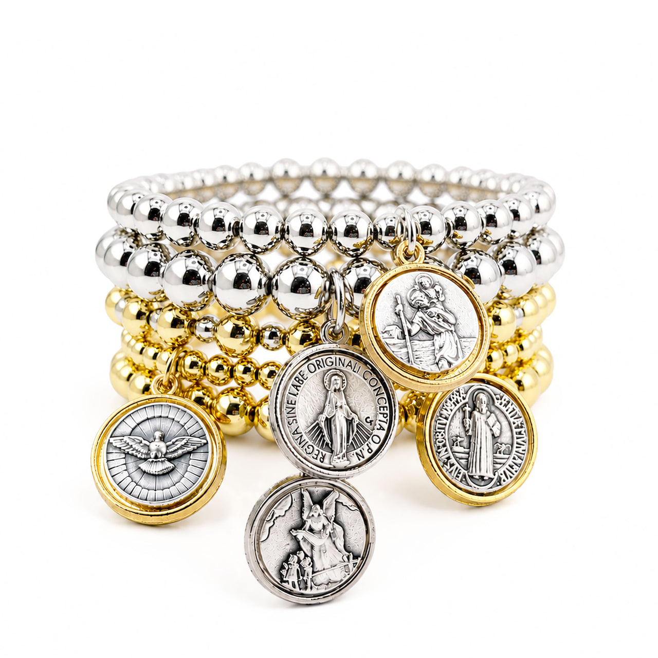 Stack of gold and silver beaded bracelets with religious charms on a white background