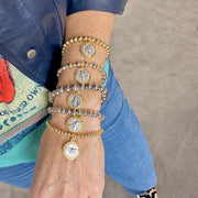 love lisa mary stack of 5 religious prayer bracelets on wrist with catholic medal charms