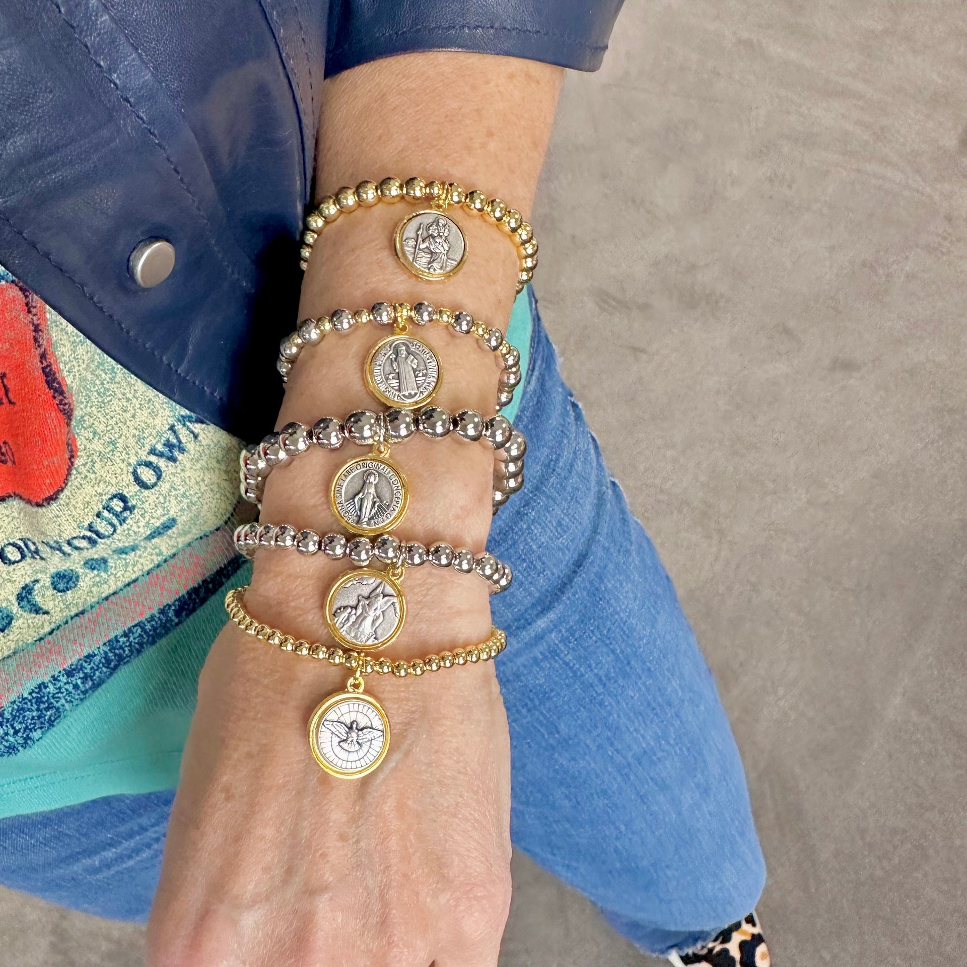 love lisa mary stack of 5 religious prayer bracelets on wrist with catholic medal charms