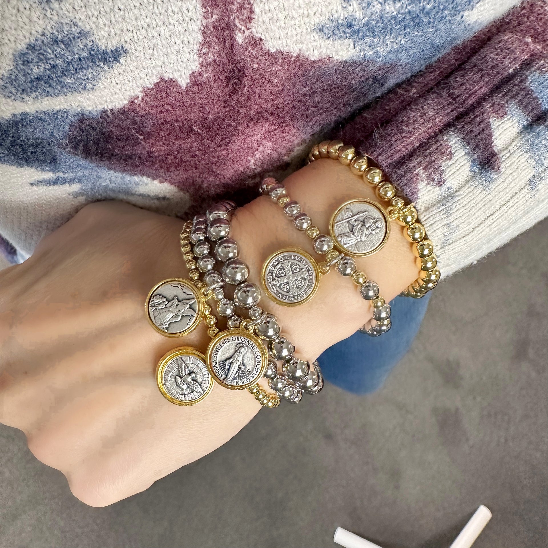 love lisa mary stack of 5 religious prayer bracelets on wrist with catholic medal charms