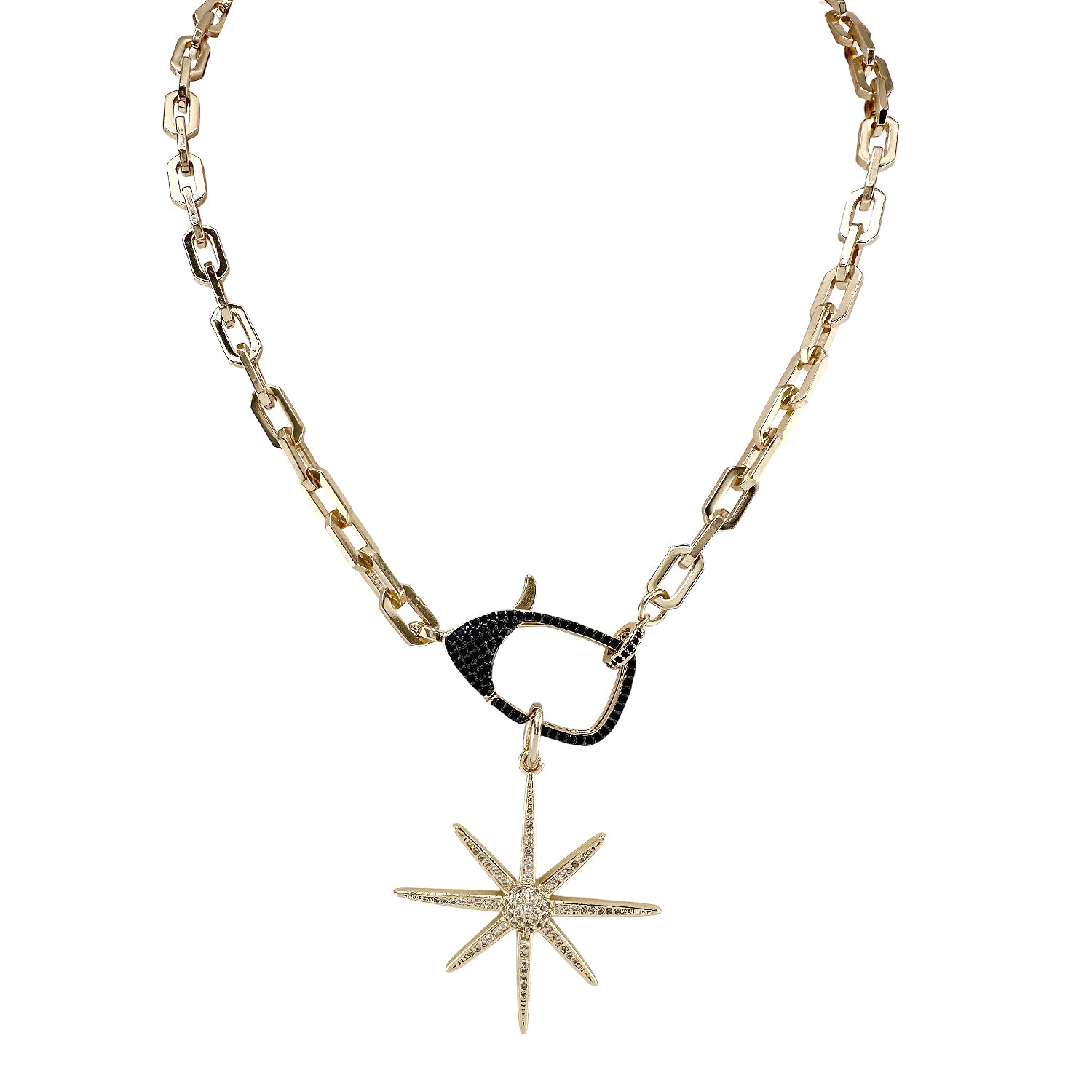 Gold necklace with black north star pendant on a white background