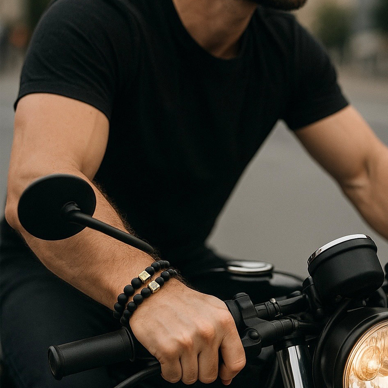 Man riding motorcycle wearing men's black onyx bracelets