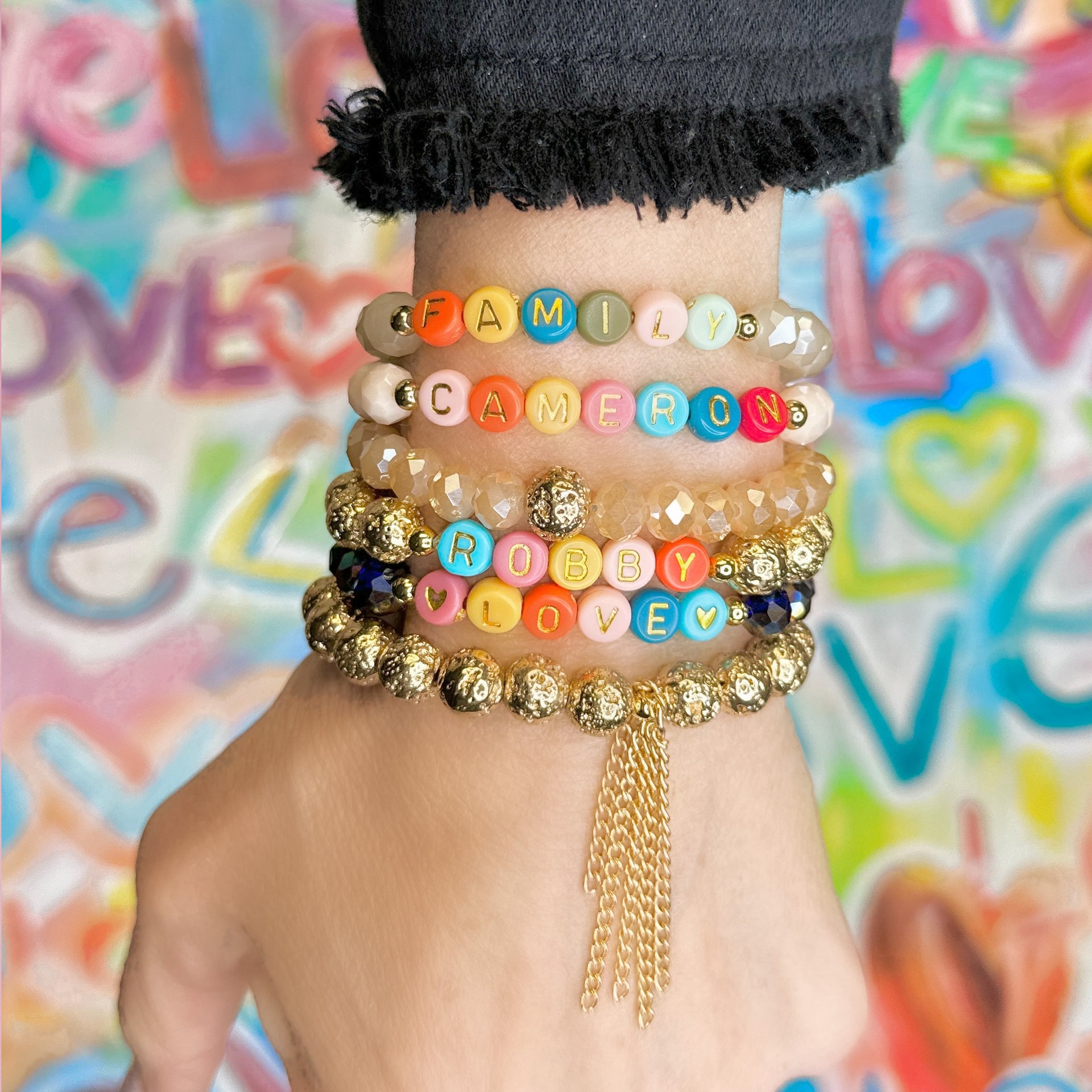 Stack of colorful personalized bracelets with custom letter beads for any name or message