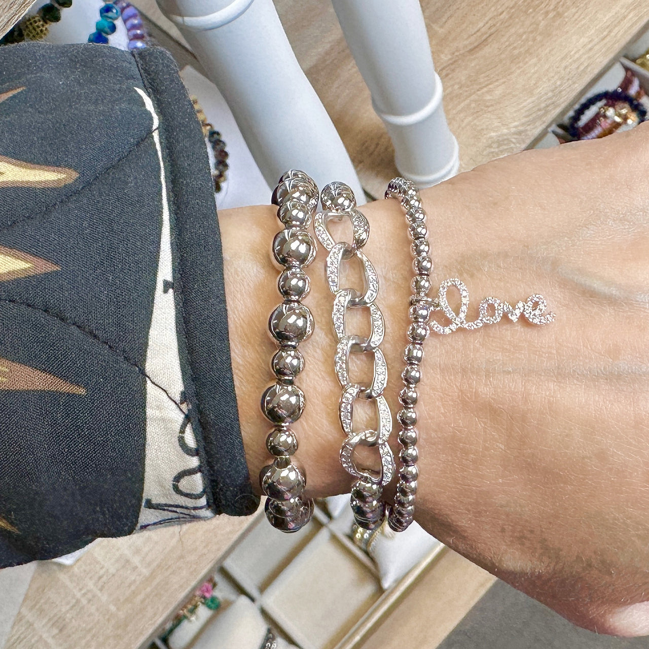 Close-up of Mia Diamond Link Bracelet in silver with 6mm beads and sparkling crystal links stacked on wrist