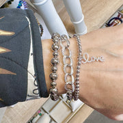 Close-up of Mia Diamond Link Bracelet in silver with 6mm beads and sparkling crystal links stacked on wrist