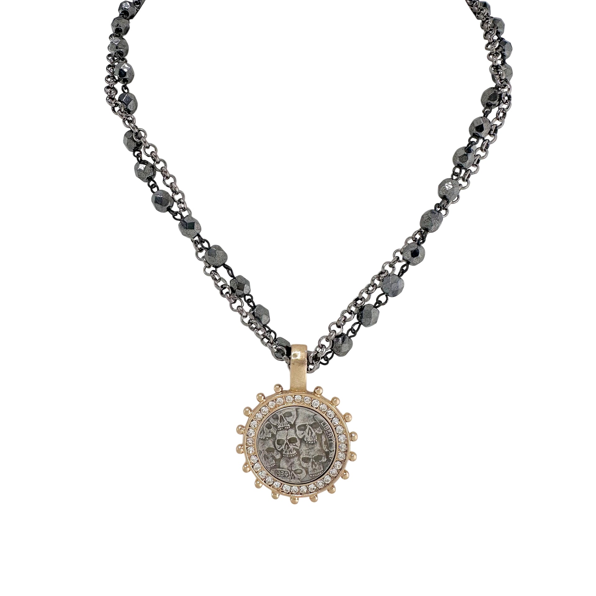 necklace-gunmetal-gold-flatlay	gunmetal and gold skull coin charm necklace with dual chain and crystal detailing