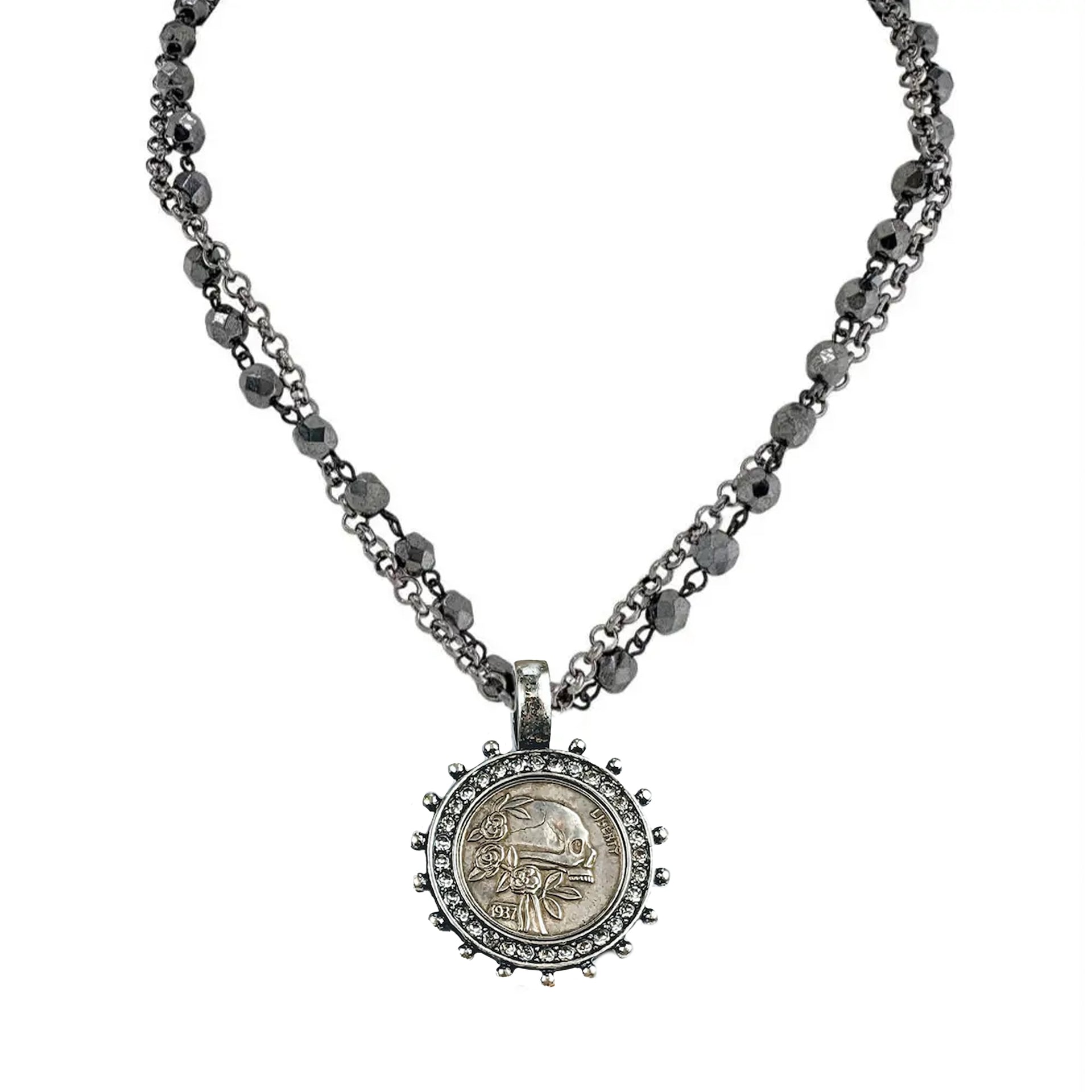 necklace-gunmetal-gold-flatlay	gunmetal and gold skull coin charm necklace with dual chain and crystal detailing