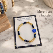 Love Lisa Mini Worry Stone Harper Luxe Crystal Rhythm Bracelet displayed on a Hold This Breathe message card with blue crystal beads and gold accents