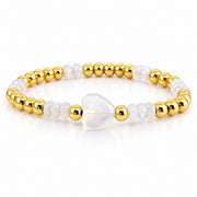 Mini Worry Stone Harper Luxe Crystal Rhythm Bracelet in Opal/Gold with white opal beads, polished gold beads, and white mini heart worry stone
