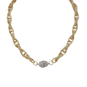 A gold chain necklace with textured links and a pavé crystal magnetic clasp