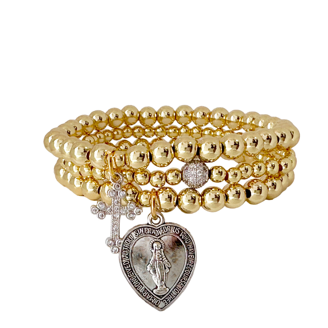A gold-colored bracelet featuring a series of round beads, a cross charm, and a larger heart-shaped charm with a depiction of the blessed mother.