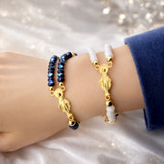 Miraculous Rosary Catholic bracelet shown stacked on wrist
