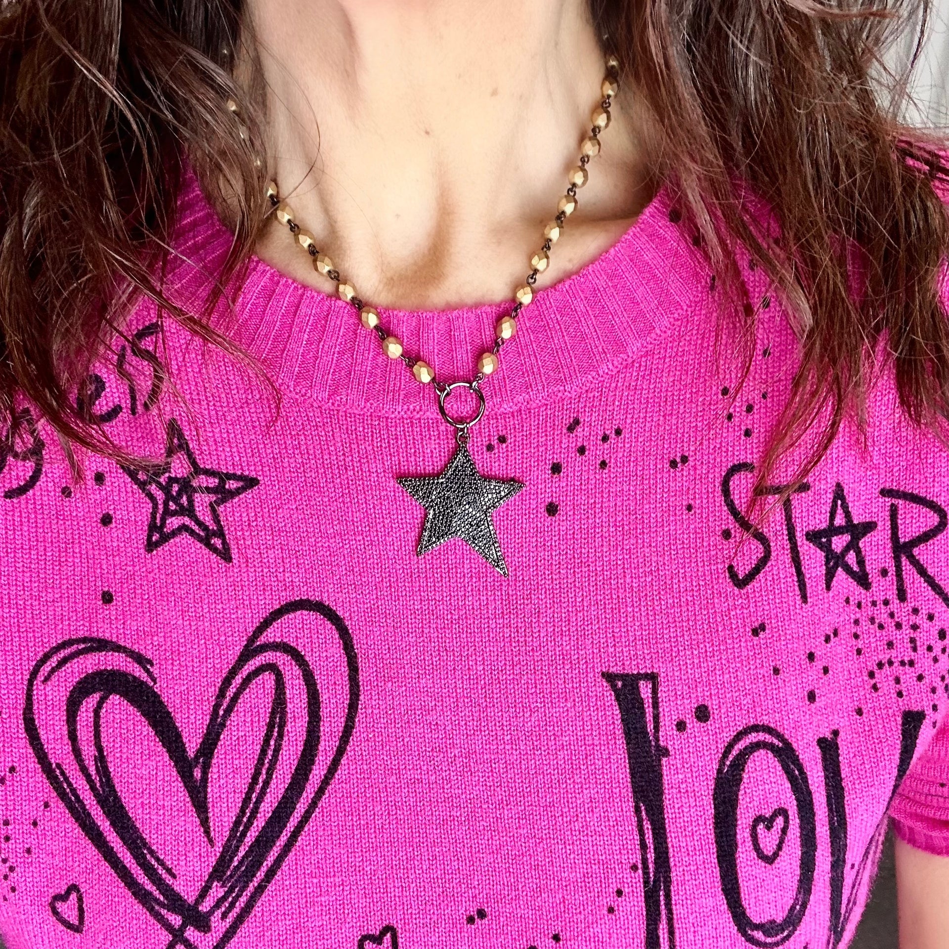 Love Lisa model in pink top wearing celestial star necklace