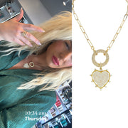 model wearing gold stellar heart necklace with spike details