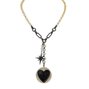 Lariat necklace with heart medallion and starburst charm in gold and gunmetal finish