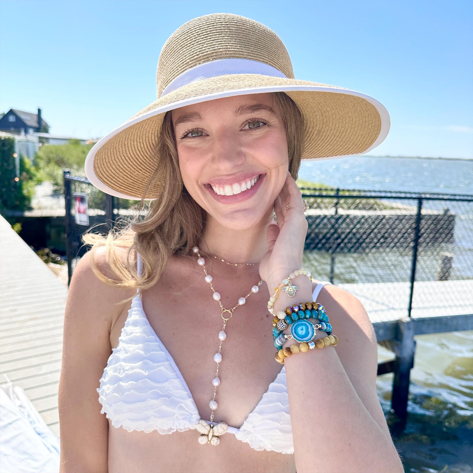 monarch butterfly necklace on a model in the pearl version