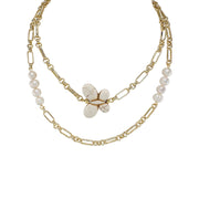 Gold chain necklace with pearl beads and a central stone on a white background