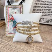 Myra's Religious Saint Stack featuring Saint Christopher, Padre Pio, and Miraculous Medals for spiritual protection and healing