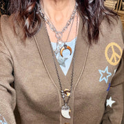 model wearing silver natural shell horn pendant necklace with crescent pendant and pave crystal details by Love Lisa