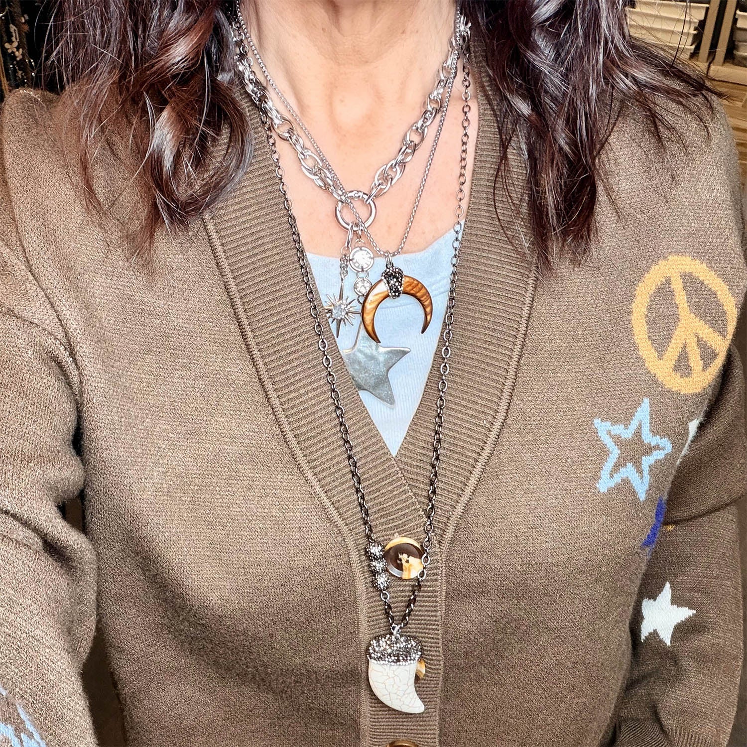 model wearing silver natural shell horn pendant necklace with crescent pendant and pave crystal details by Love Lisa