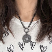 love lisa model wearing nova luxe round pendant gunmetal pave north star necklace
