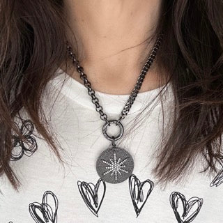 love lisa model wearing nova luxe round pendant gunmetal pave north star necklace