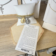 padre pio healing bracelets shown on a pillow with a prayer card