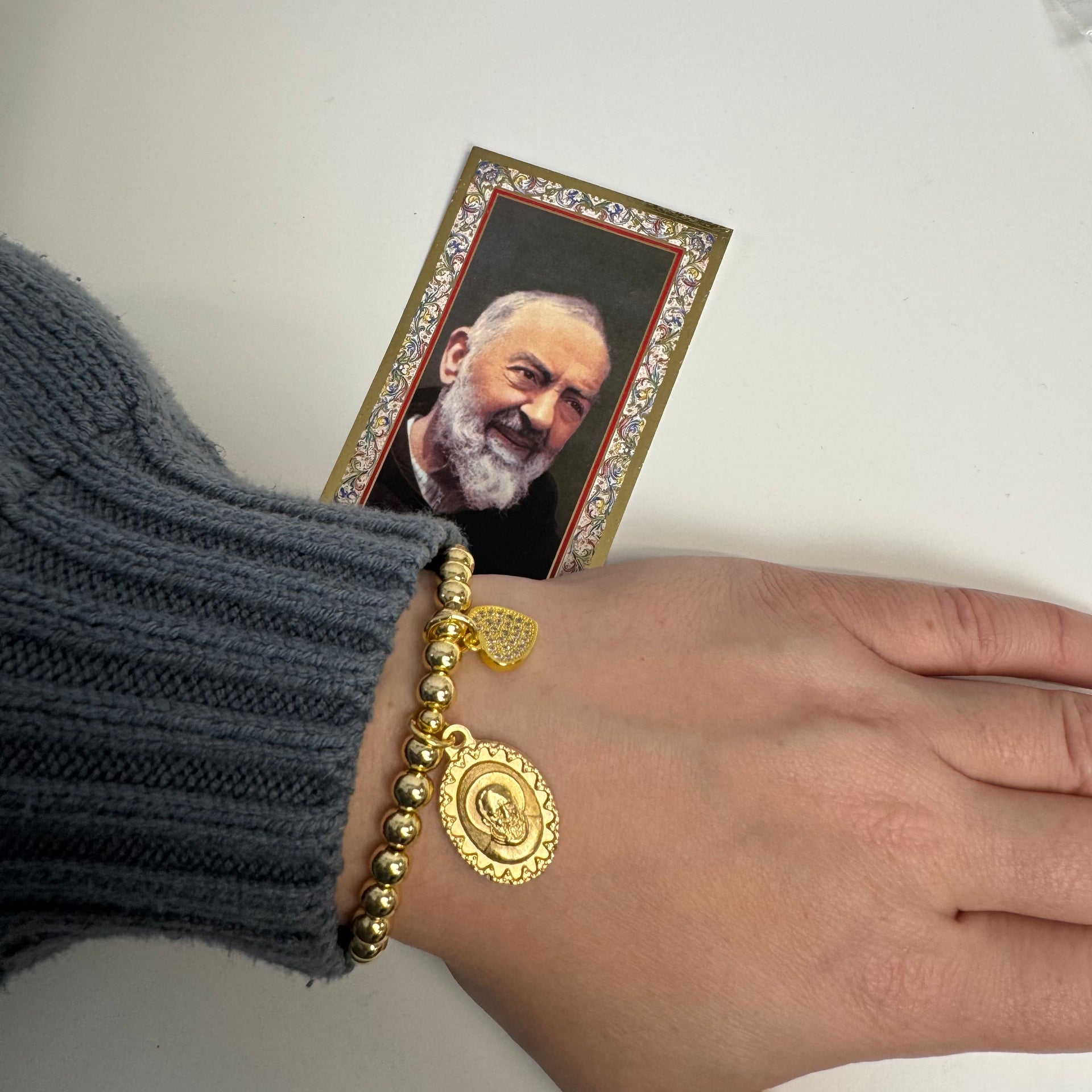 padre pio love bracelet gold saint pio beaded bracelet with heart charm shown on wrist