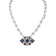 Necklace with eye-shaped pendant and beaded chain on a white background