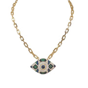 Gold necklace with a decorative pendant featuring green and blue stones on a white background