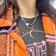 Model wearing Pavé Moon Charm on silver clasp necklace with tee and plaid orange coat
