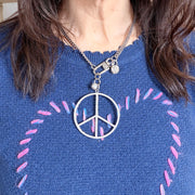 Love Lisa peace keeper statement necklace  and hanging crystal accents worn silver pavé peace sign statement look