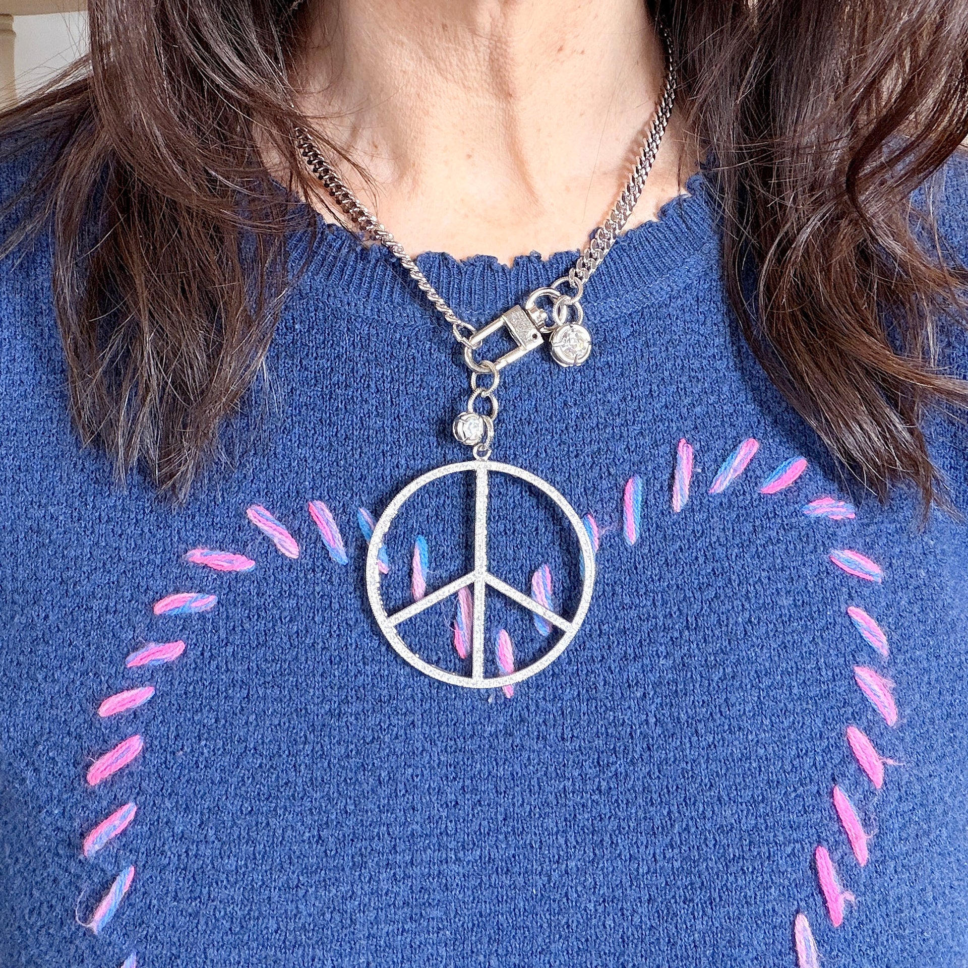 Love Lisa peace keeper statement necklace  and hanging crystal accents worn silver pavé peace sign statement look