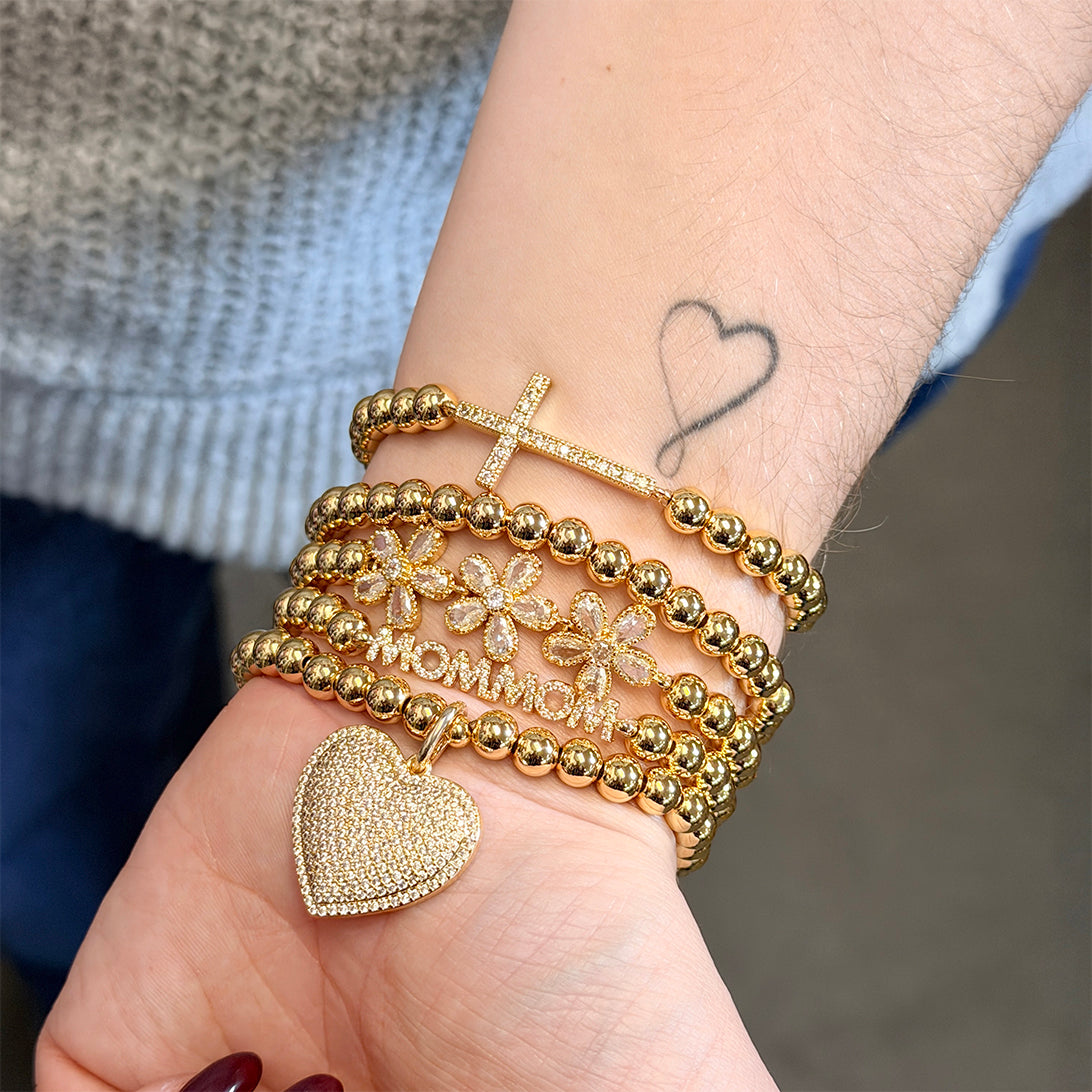 stacked gold crystal mommom letter bracelet on wrist by love lisa jewelry