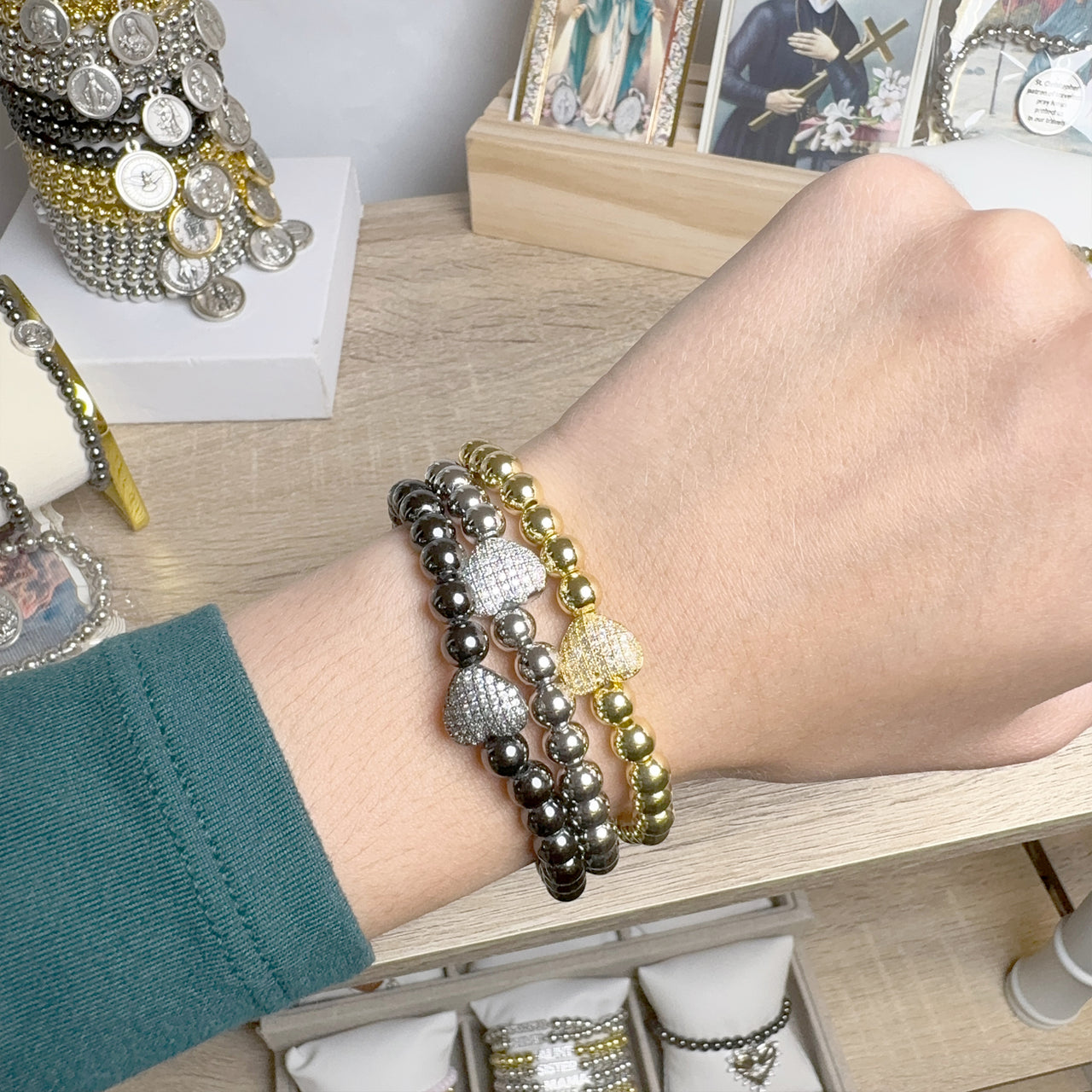 love lisa perfect medium size heart bracelets in rose gold gold and silver stacked on wrist

