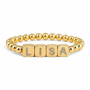 personalized large block letter bracelet in gold spelling LISA with bold cube letters and polished 6mm beads