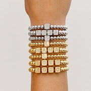 Love Lisa personalized large block letter bracelets stacked on wrist in gold silver and gunmetal bead styles