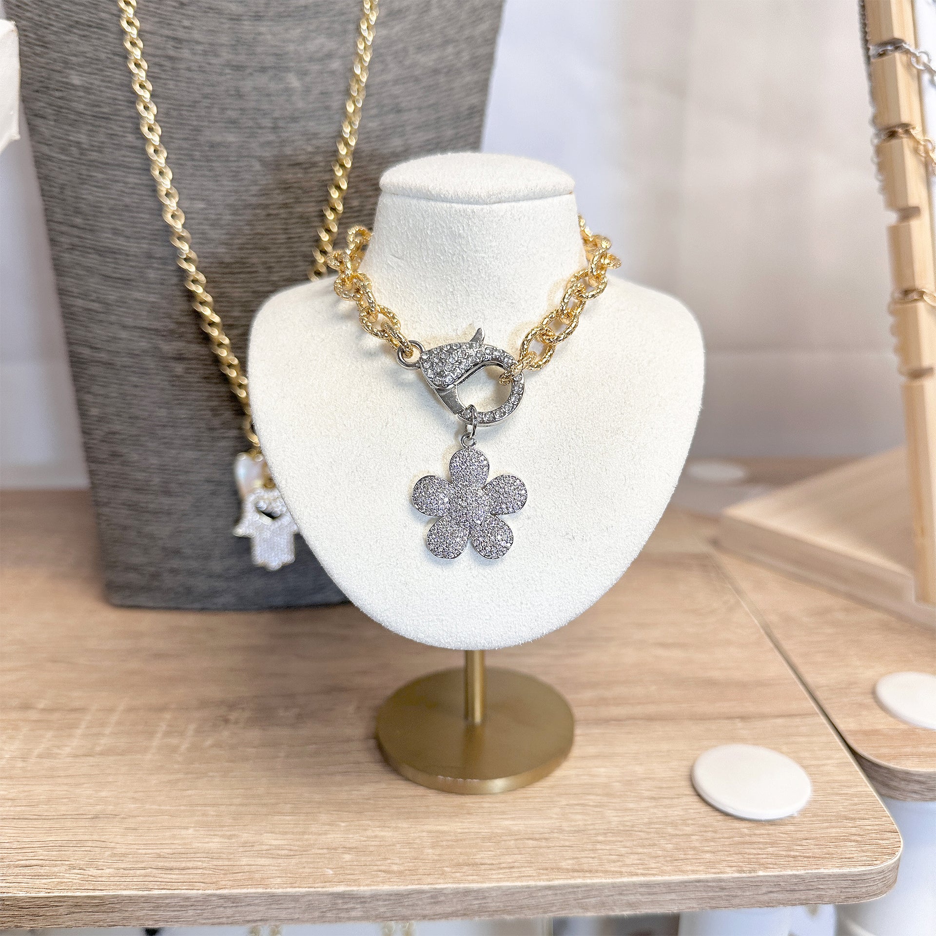 love lisa petal pop flower charm in silver pave crystal charm for necklaces and bracelets on necklace on display