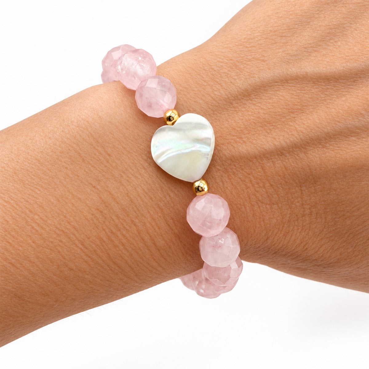Love Lisa Rose Quartz Mother of Pearl Worry Stone Bracelet worn on wrist with faceted pale pink beads, iridescent heart focal, and gold-tone accents