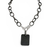 Black chain necklace with a rectangular pendant on a white background