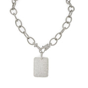 Silver chain necklace with a textured square pendant on a white background